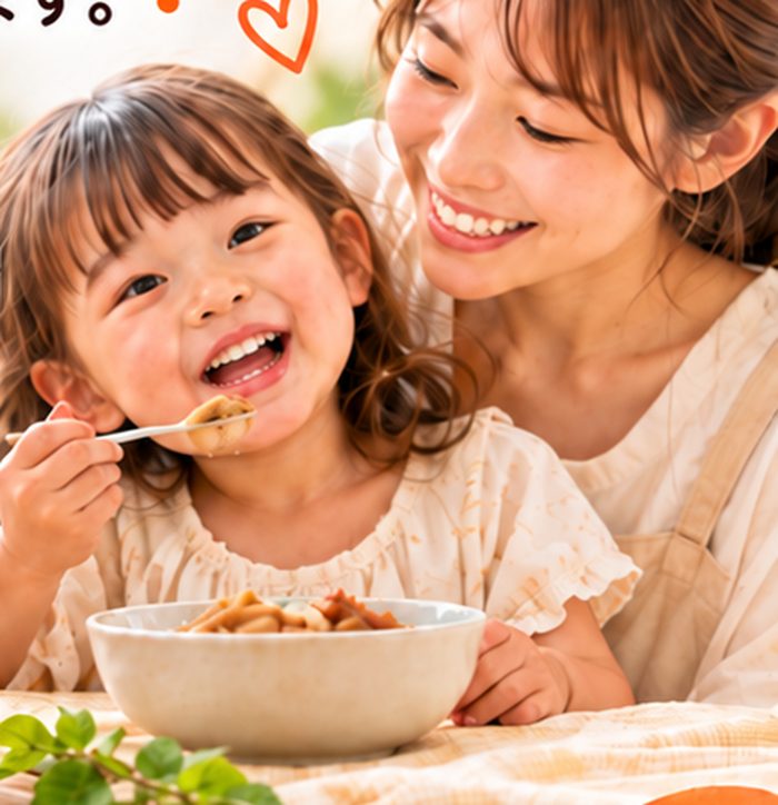 ごぼうペーストを食べて笑顔になる子どもと、寄り添うお母さん（イメージ）